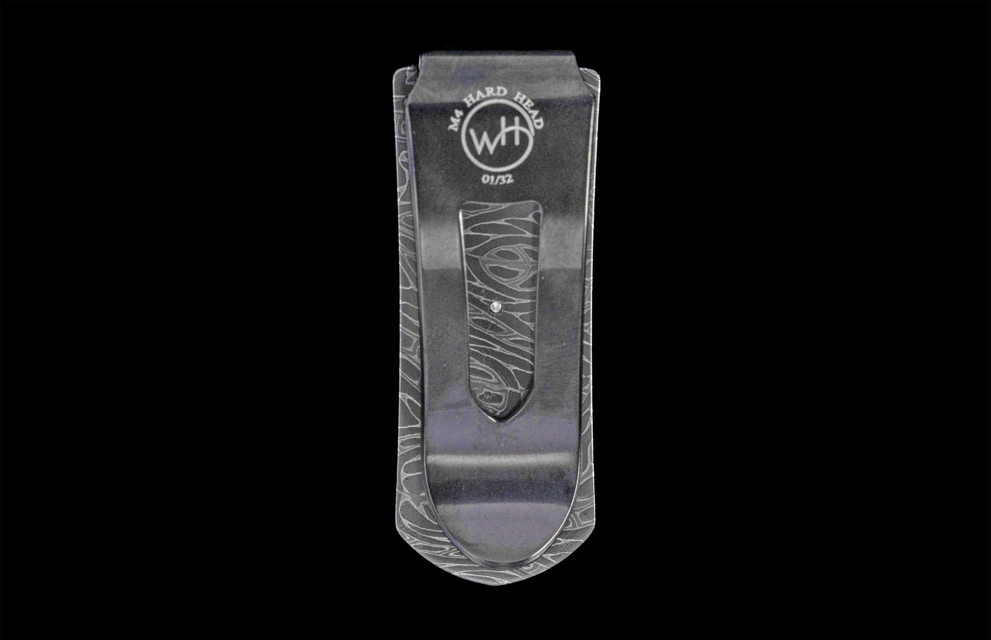 Grey metallic money clip etched with a wavy pattern, featuring "M4 HARD HEAD" text, a "WH" logo, and "01/32" serial number.