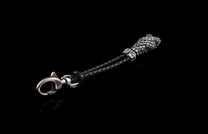 William Henry key fob features a sterling silver snake head and a round-braided black leather cord