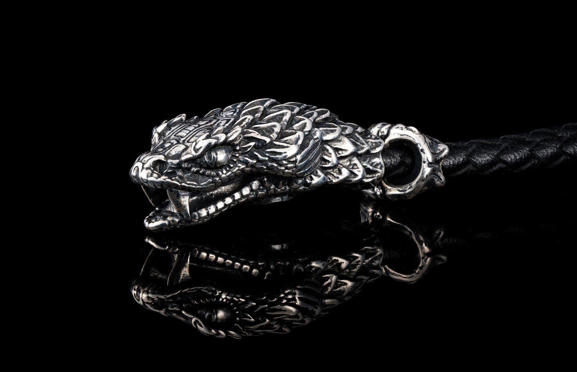 William Henry key fob features a sterling silver snake head and a round-braided black leather cord