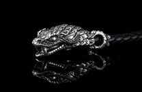 William Henry key fob features a sterling silver snake head and a round-braided black leather cord