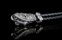 William Henry key fob features a sterling silver snake head and a round-braided black leather cord