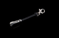 William Henry key fob features a sterling silver skull with Egyptian detailing, a round-braided black leather cord, and a  stainless steel hook 