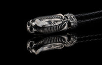 William Henry key fob features a sterling silver skull with Egyptian detailing, a round-braided black leather cord, and a  stainless steel hook 