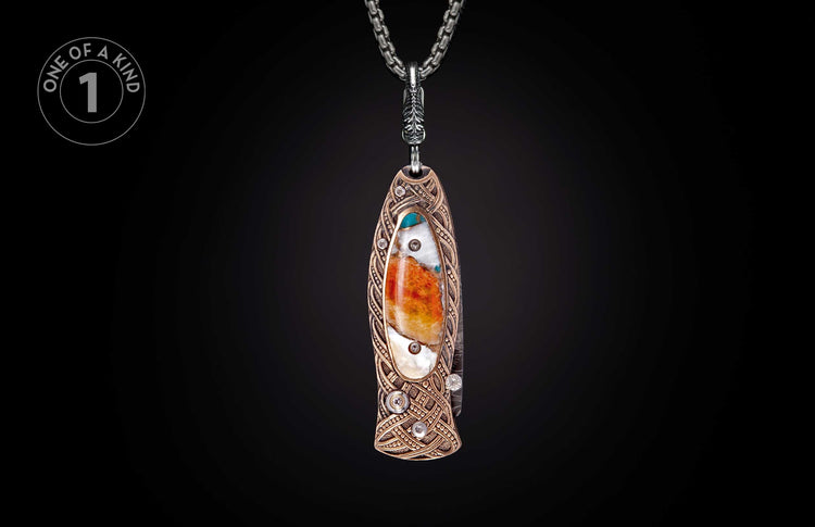Ornate knife pendant with orange, white, and blue stone, bronze Celtic knotwork, and clear accent stones on a silver chain.