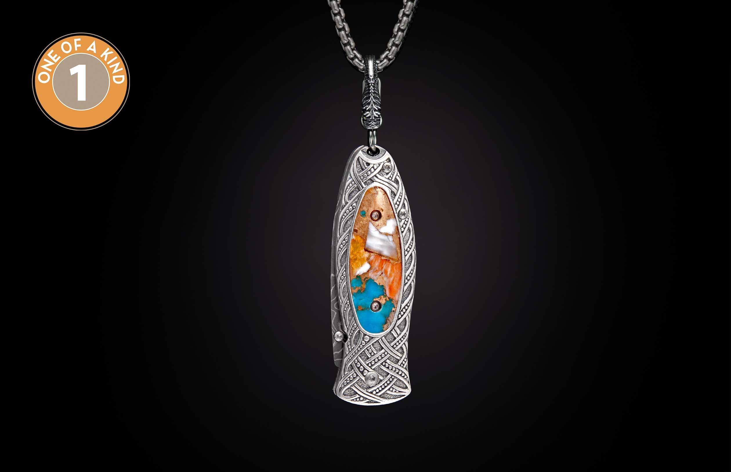 Ornate silver knife with Celtic knot engraving and vibrant turquoise and orange stone inlay, "one of a kind" label visible.