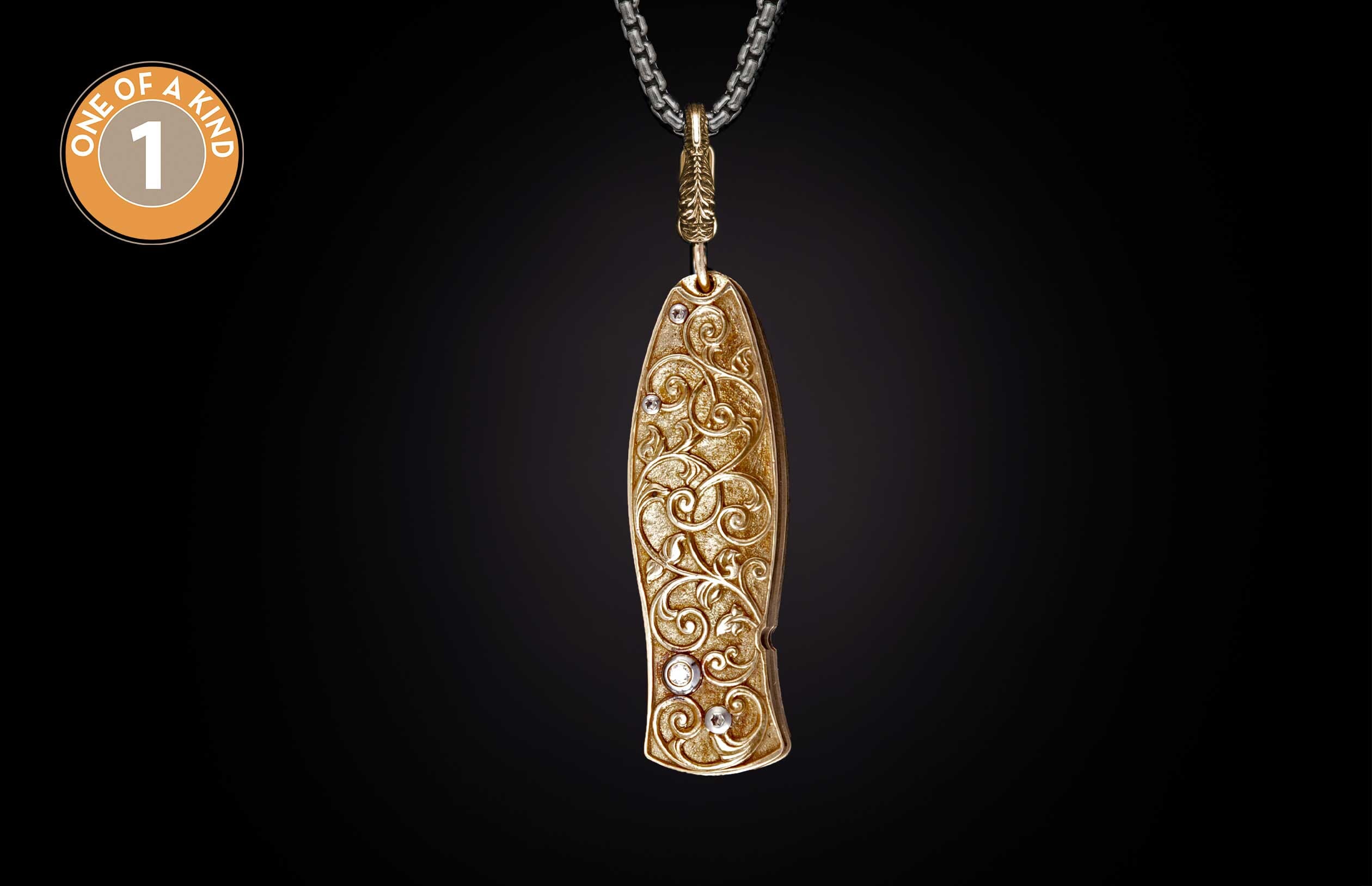 Golden ornate knife with intricate scrollwork and embedded white gemstones, hanging from a silver chain.
