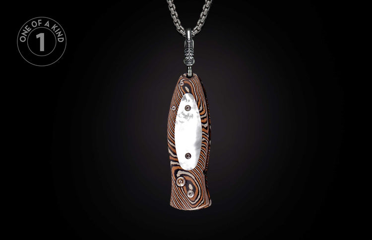 Miniature knife pendant with a striped brown and black handle, silver-toned metal clip, hanging from a heavy silver chain.