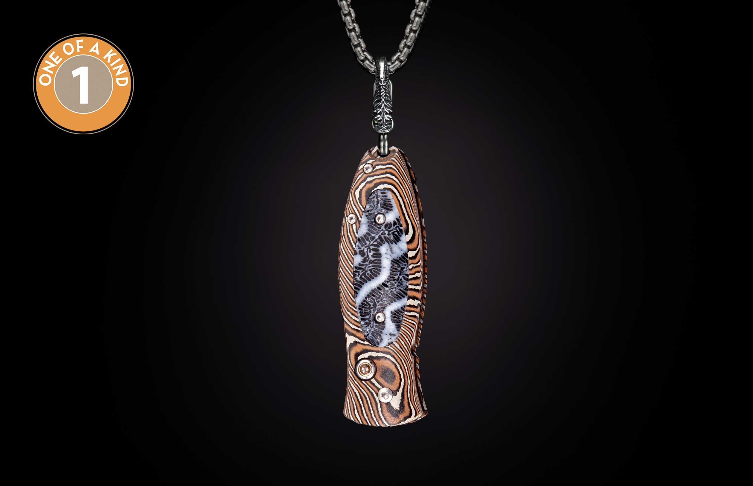 Knife with layered brown and cream pattern, featuring a central fossilized coral inlay, hanging from a silver chain.