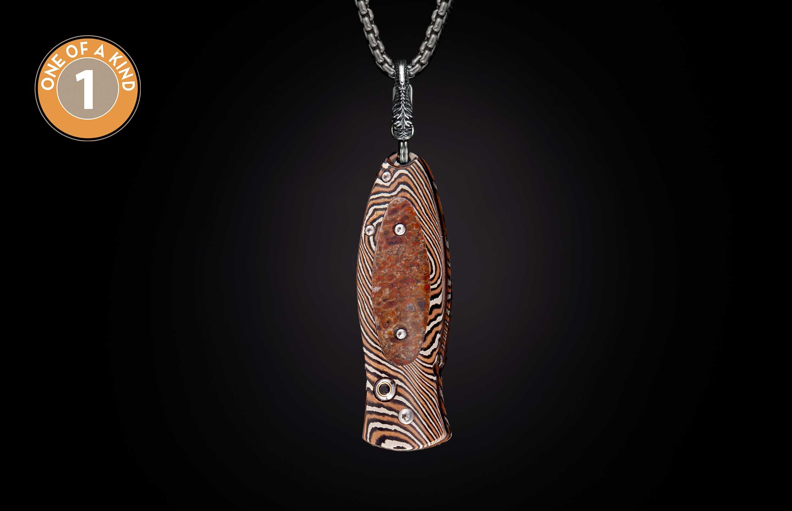 Knife with a brown and white wavy striped handle, featuring a mottled reddish-brown insert with silver rivets, hanging from a silver chain.