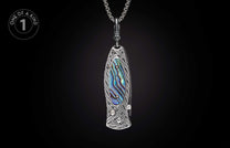 Ornate silver-toned pendant knife with abalone inlay, intricate Celtic knot engraving, and sparkling gemstones.