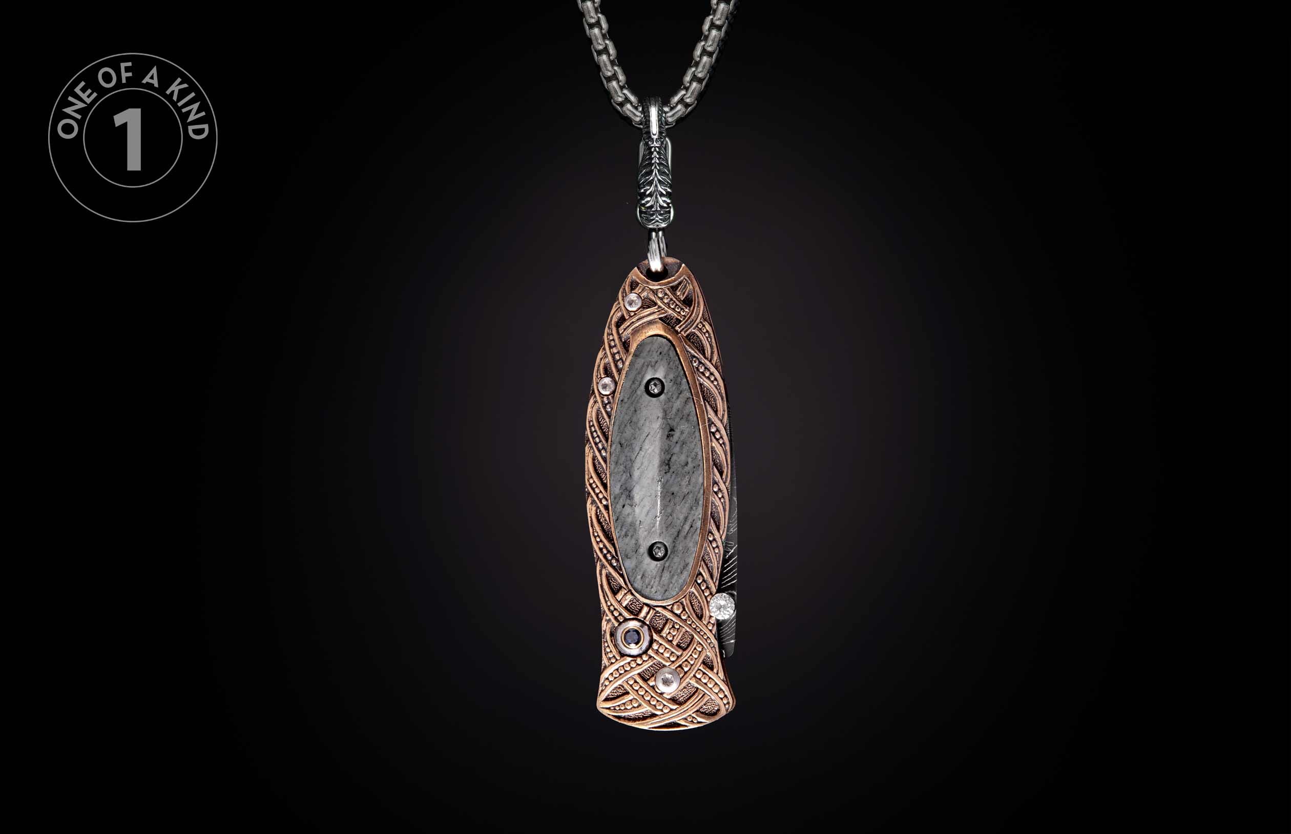 Ornate knife pendant featuring a gray stone inlay and bronze Celtic knotwork design on a silver chain.