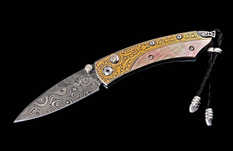 Ornate folding knife with Damascus steel blade, iridescent mother-of-pearl handle, gold engraved frame, and jeweled accents.