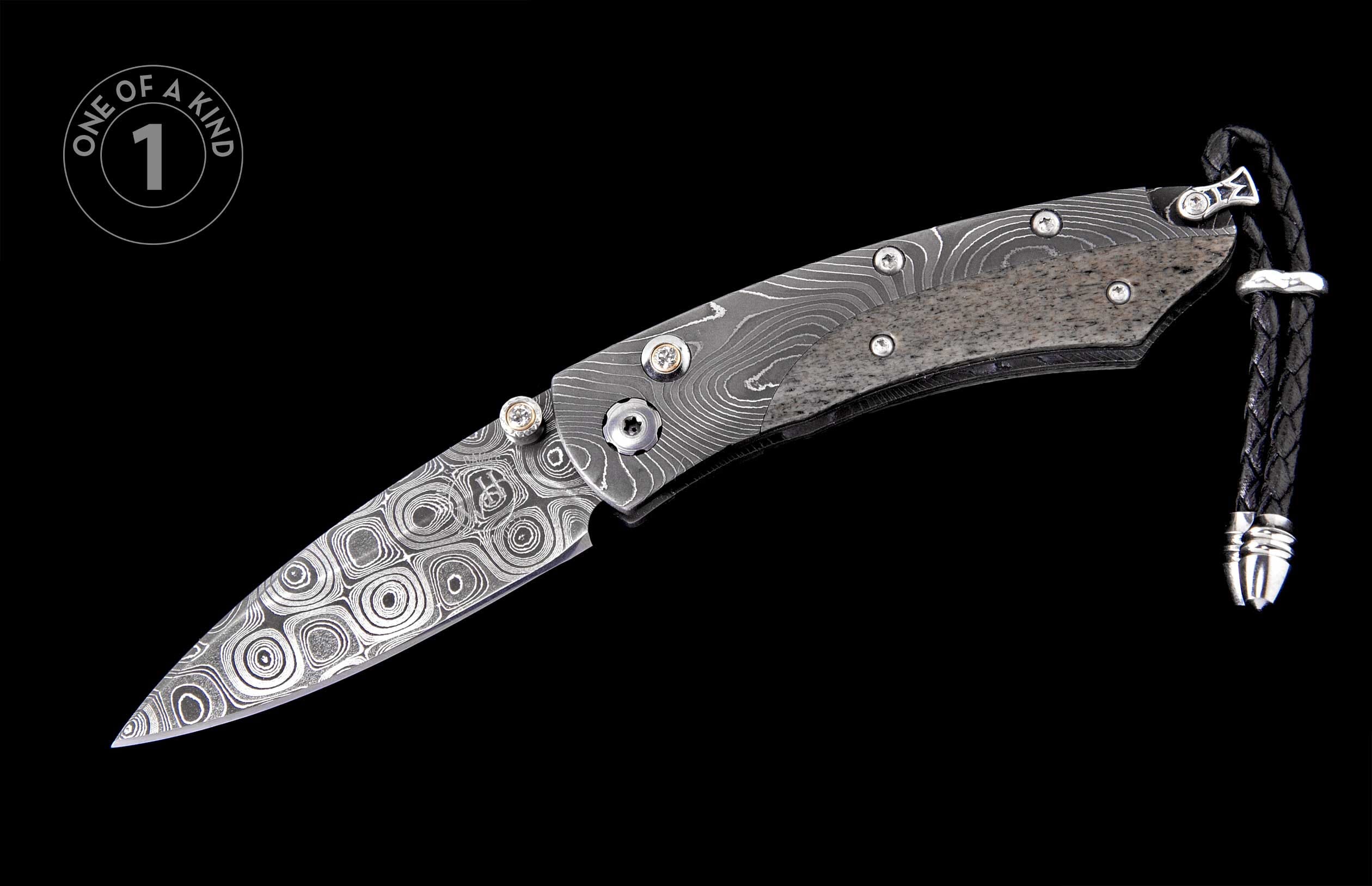 Folding knife with swirling Damascus blade, textured grey handle, decorative thumb studs, and braided leather lanyard.