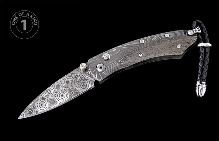 Folding knife with swirling Damascus blade, textured grey handle, decorative thumb studs, and braided leather lanyard.