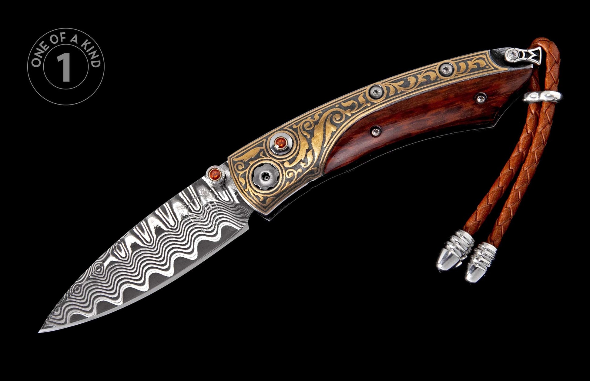 Folding knife with Damascus steel blade, dark wood handle, gold-toned engraved bolsters with orange gemstones, and a braided leather lanyard.