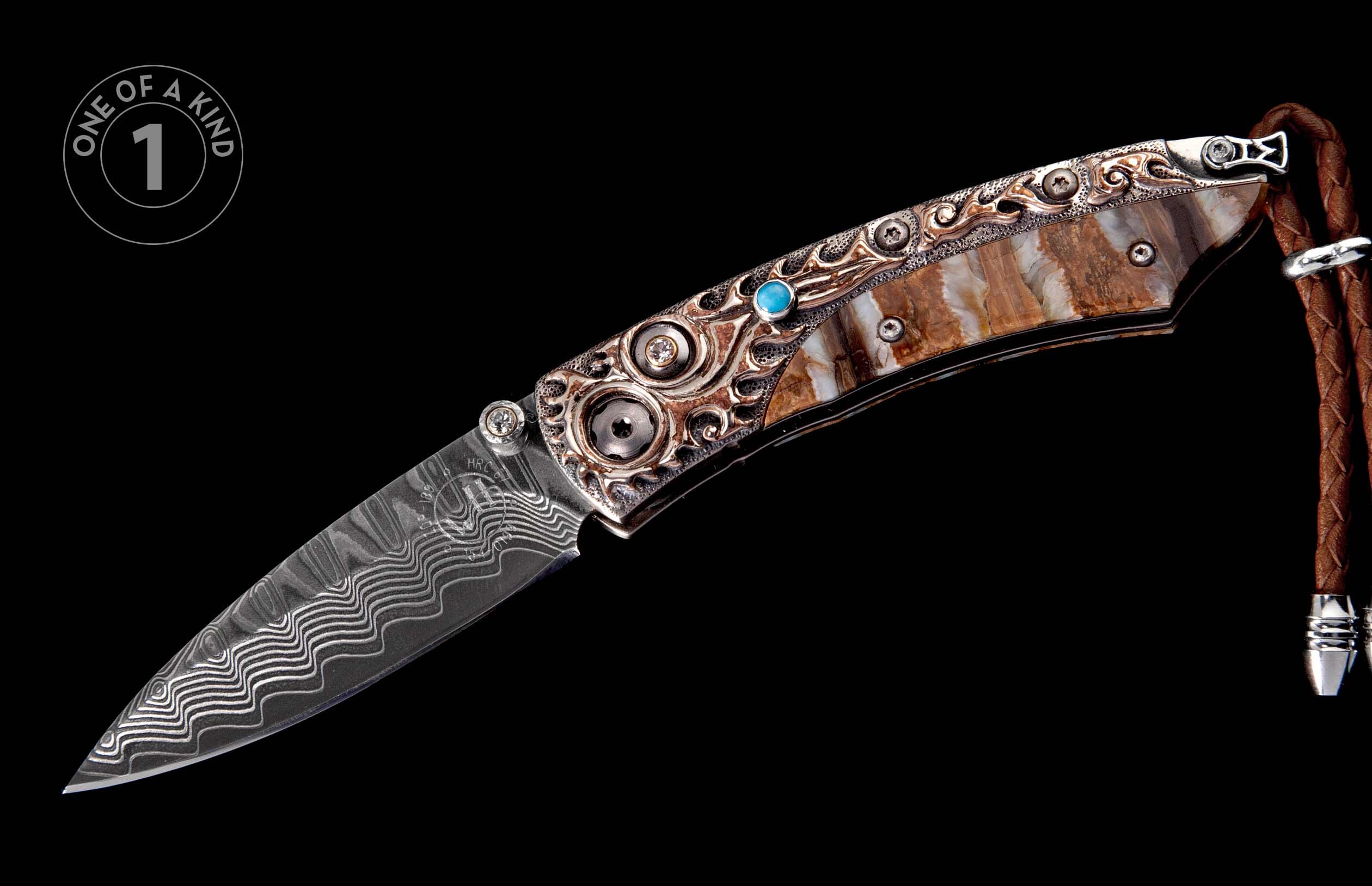 Ornate folding knife with Damascus blade, intricately engraved silver handle, blue gemstone, diamonds, and brown fossilized ivory, with a braided leather lanyard.