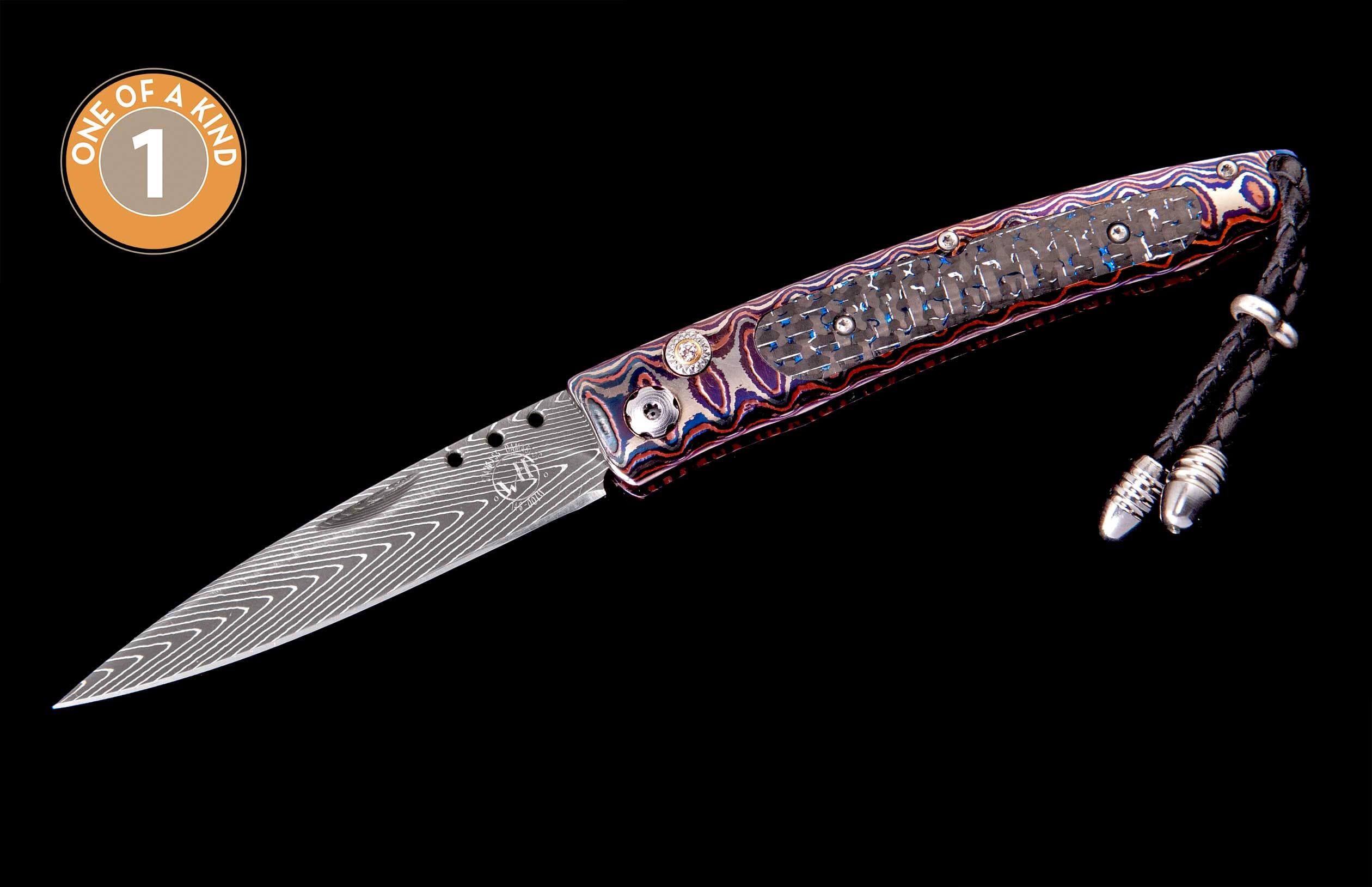 Folding knife with Damascus blade and multicolored handle, featuring a carbon fiber inlay, braided leather lanyard, and "One of a Kind" badge.