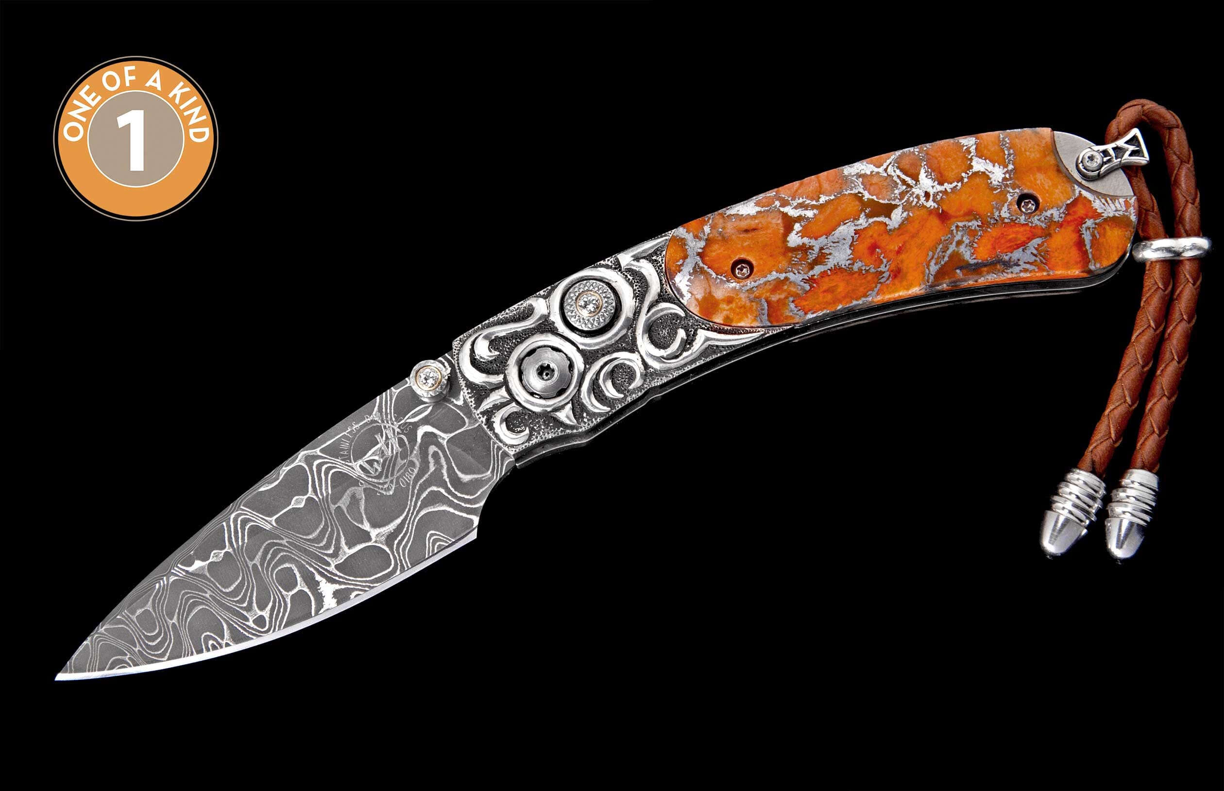 Damascus steel folding knife with ornate silver-toned metal and orange mottled scales, featuring a braided leather lanyard.