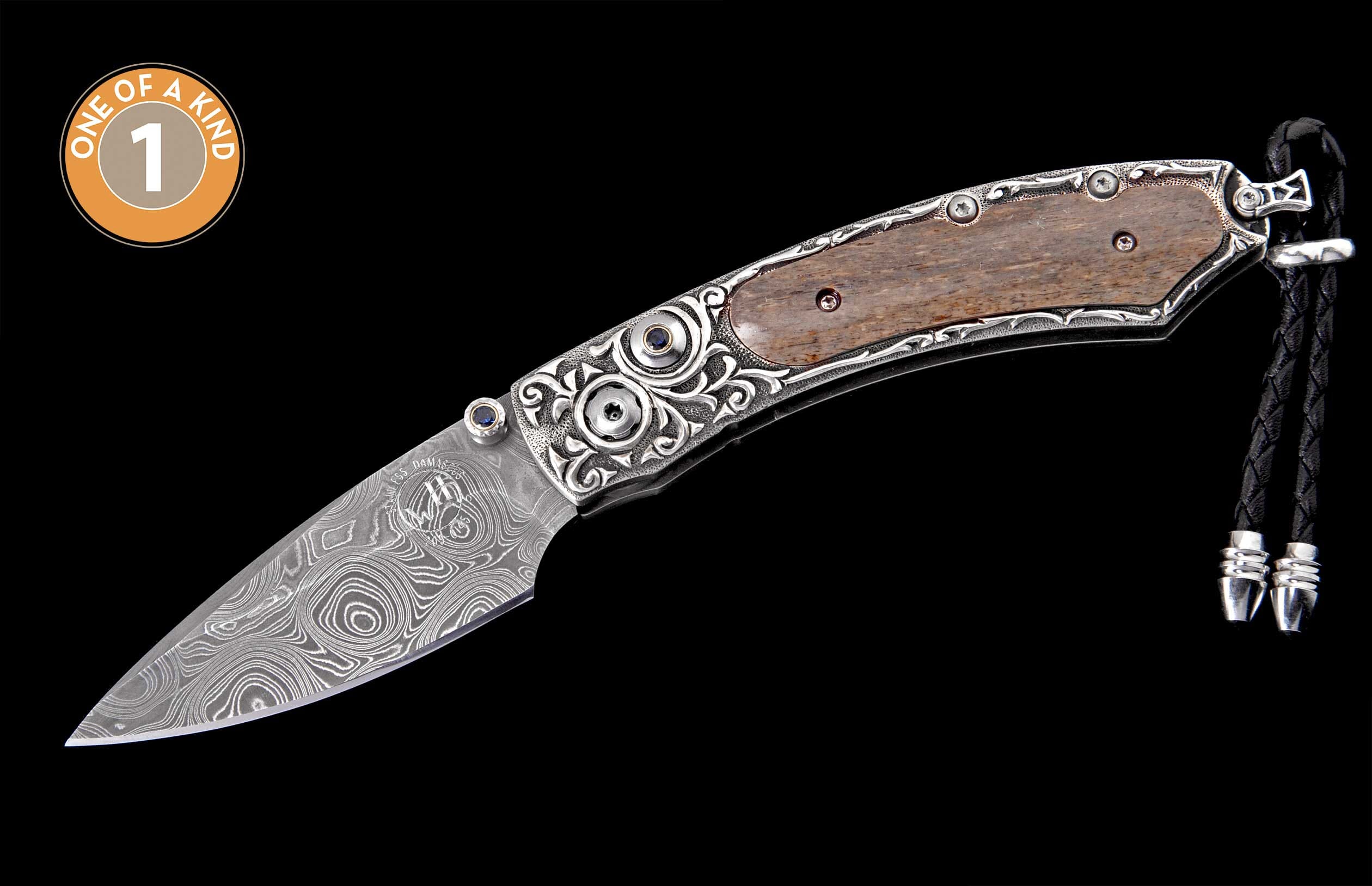 Custom folding knife with a swirling Damascus blade, intricately engraved silver handle featuring wood and blue accents, plus a leather lanyard.