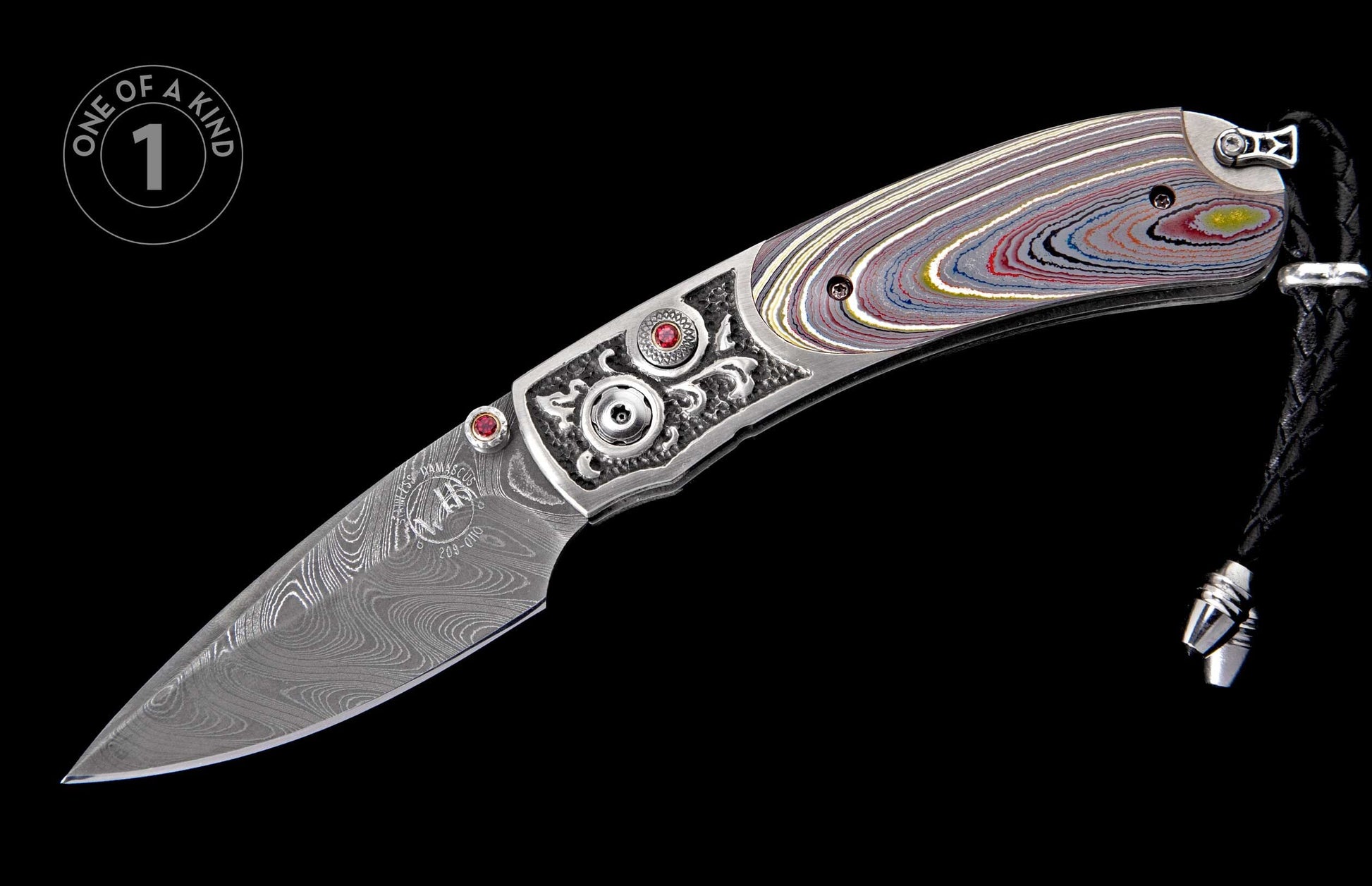 Damascus steel folding knife with a colorful layered handle, ornate silver bolster, red gems, and a braided leather lanyard.