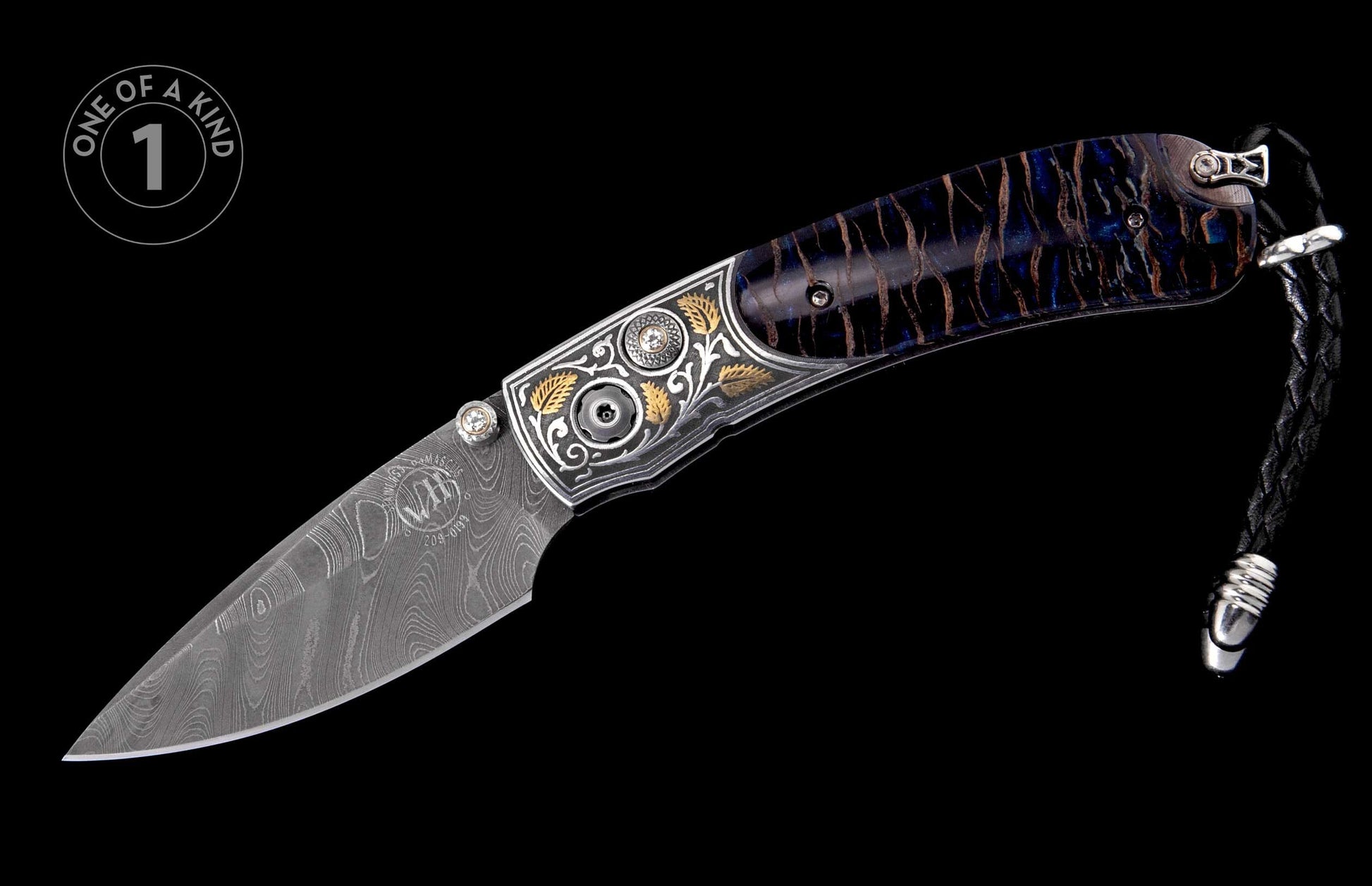 Ornate folding knife with Damascus steel blade, silver and gold leaf engraved bolster with a jeweled pivot, and dark blue streaked handle with a braided leather lanyard.