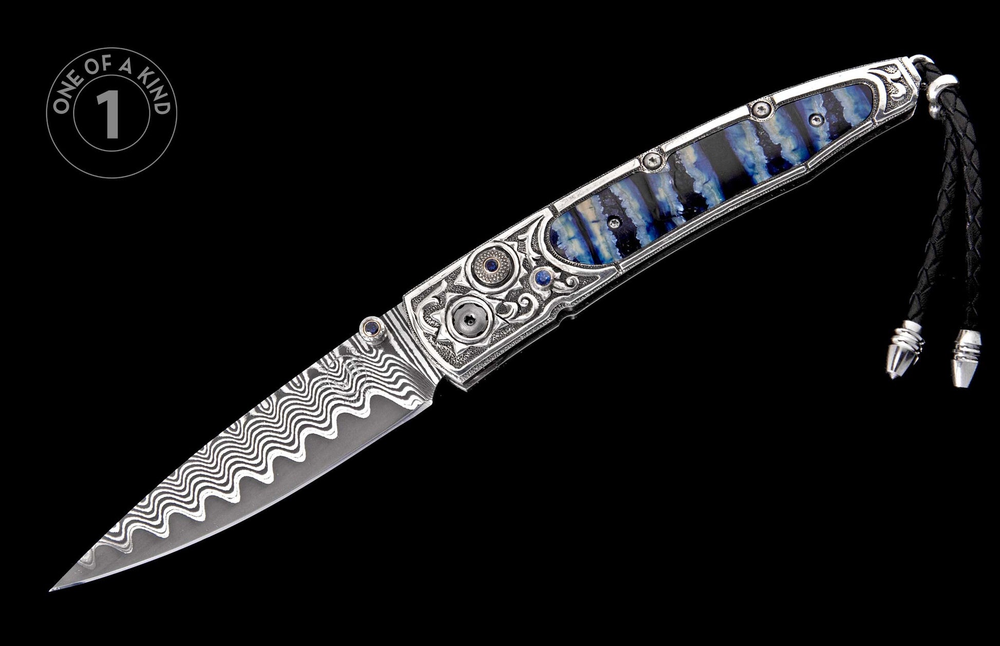 Ornate open folding knife featuring wavy Damascus steel blade, silver handle with blue striped inlay, and sapphire accents.