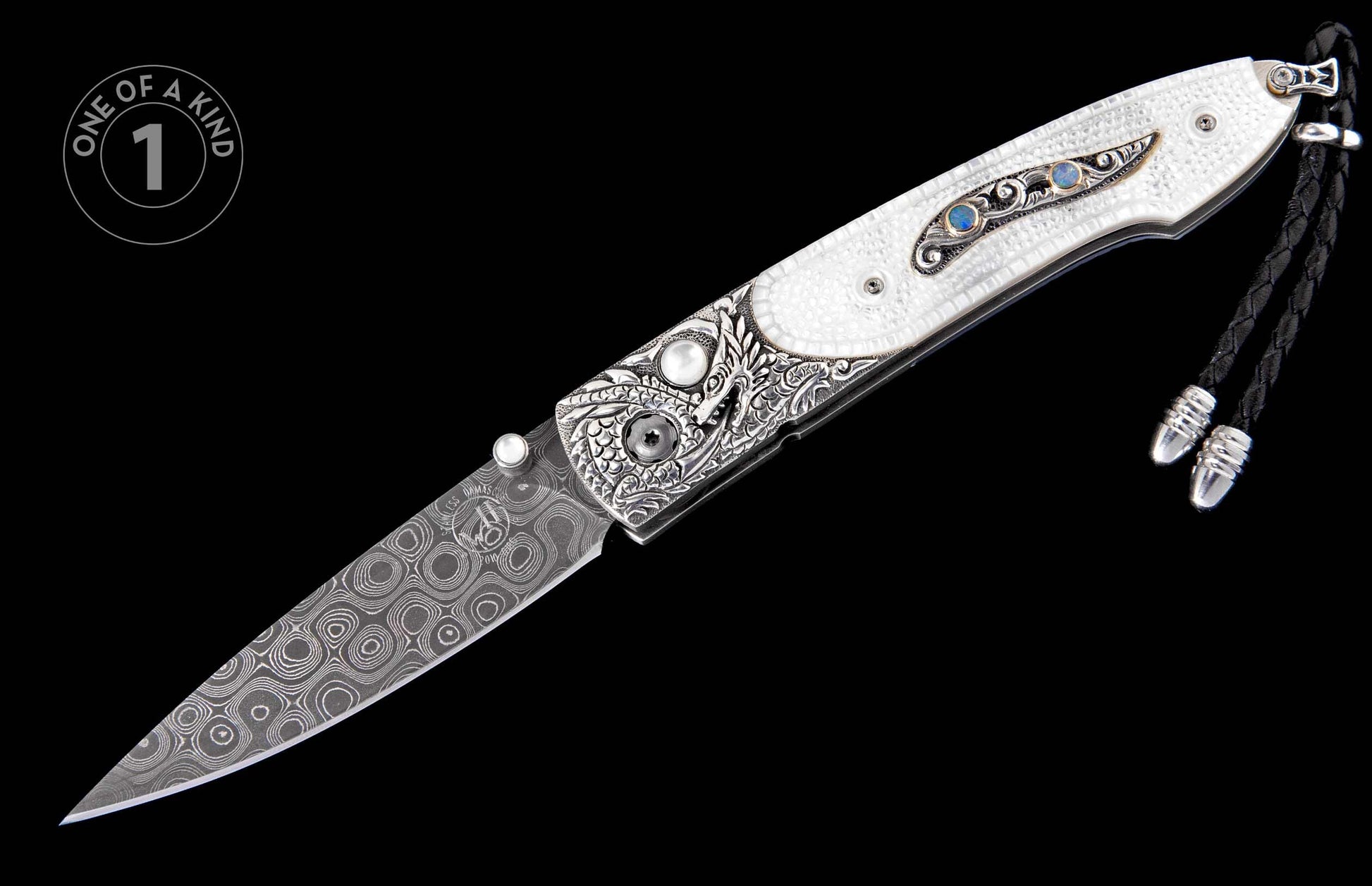 Folding knife with a white textured handle, intricate silver engraving, blue opal inlays, a patterned Damascus blade, and a black braided lanyard.