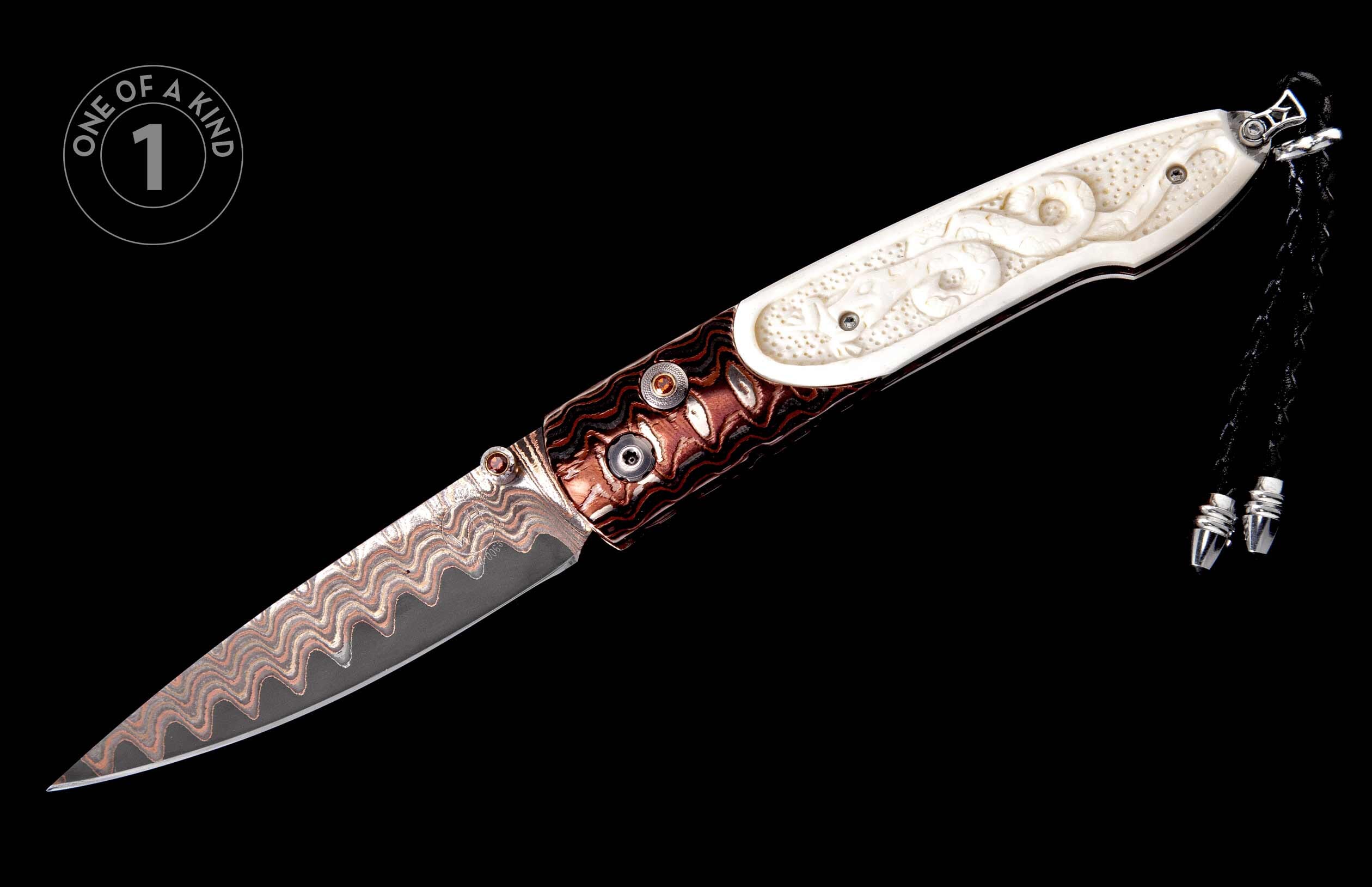 Ornate folding knife with a carved cream handle featuring serpentine designs, a wavy reddish-brown Damascus steel blade, and a black braided lanyard.