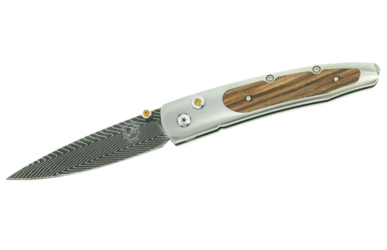 Silver folding knife with brown wood handle inlay and wavy Damascus patterned blade, featuring yellow accents.