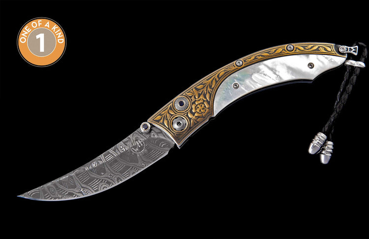 Patterned Damascus steel folding knife with an iridescent mother-of-pearl handle, gold floral engravings, blue gem accents, and a braided black leather lanyard.