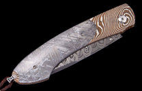 Meteorite and Damascus steel folding knife by Carefree Buffalo, featuring distinct crystalline and wavy patterns.