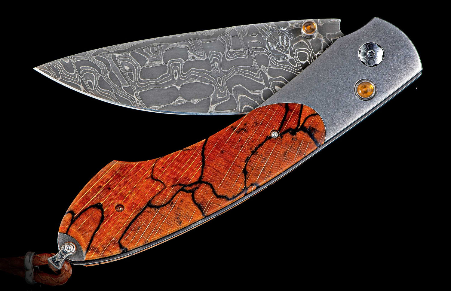 Folding knife with a patterned Damascus blade, reddish-brown spalted maple handle, and satin grey metal bolsters, displayed open.