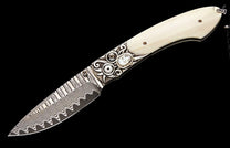 Ornate knife featuring a cream handle, intricate silver bolster with mother-of-pearl, and a wavy Damascus steel blade.