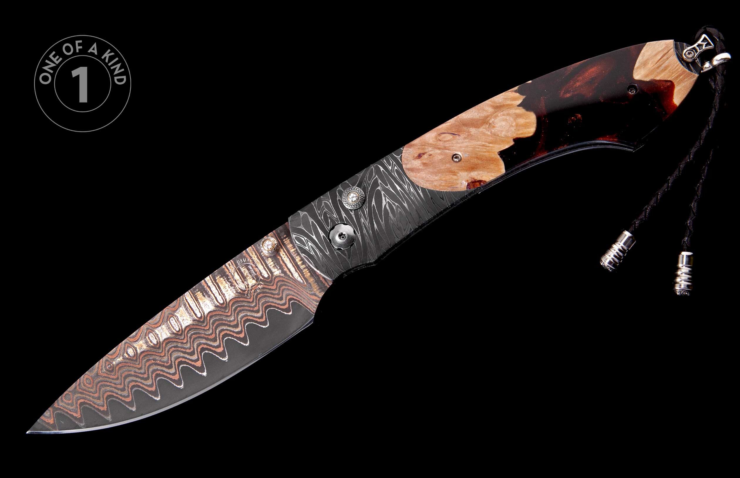 Wavy copper and silver Damascus folding knife with etched blade, matching Damascus handle, burl wood inlay, and a braided lanyard.