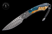 Custom folding knife with a wavy Damascus steel blade, blue resin and natural wood handle, and a braided black leather lanyard.