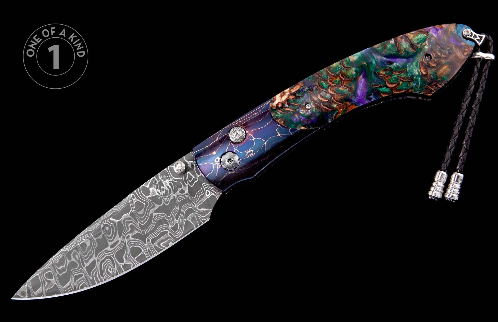 Ornate folding knife with a swirling Damascus steel blade and a multi-colored handle featuring abstract patterns, accented by a black braided lanyard.