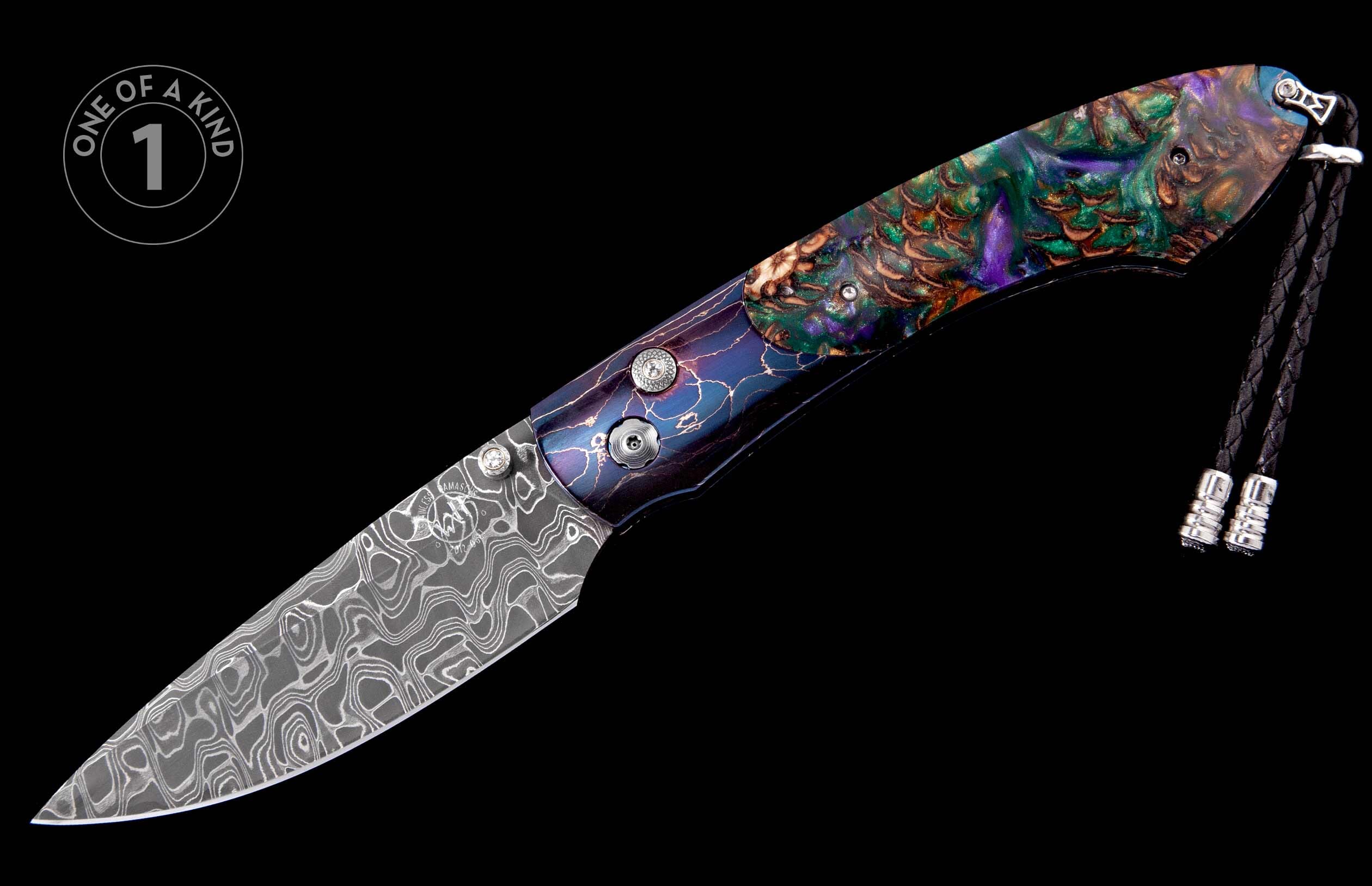 Ornate folding knife with a swirling Damascus steel blade and a multi-colored handle featuring abstract patterns, accented by a black braided lanyard.
