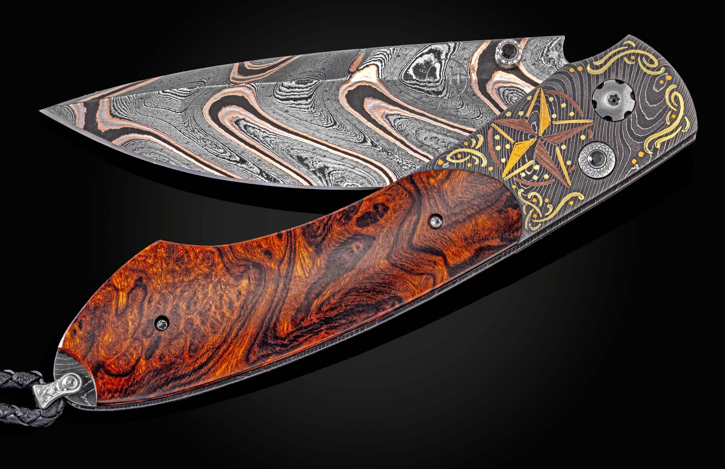 Handcrafted William Henry Knife with hand-forged damascus by Chad Nichols, hand-engraving and  24K yellow gold, 18K green gold, and copper inlays by Tyler Prince, Desert Ironwood scales, spinel gemstones, and a damascus steel blade by Baker Forge. 