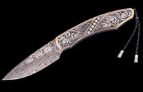 Patterned Damascus steel folding knife with an intricately engraved handle featuring gold inlay, six diamonds, and a black leather lanyard.