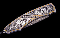 Ornate silver and gold knife with elaborate scrollwork, diamond flowers, and a patterned Damascus blade.