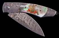 Ornate folding knife with a wavy Damascus steel blade, iridescent mother-of-pearl handle, and a gold Samurai warrior inlay.