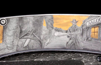 Silver-toned engraved knife featuring a detailed Western scene of a cowboy gunfight and a saloon, with gold accents.