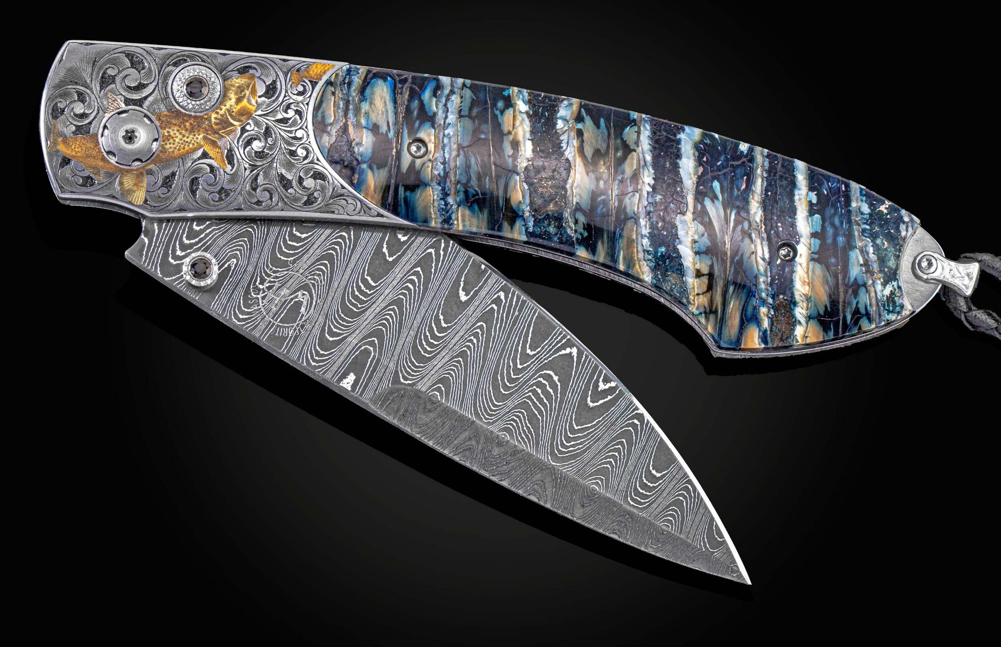 William Henry knife features a hand-engraved bolster with 24K gold, 18K green gold, and silver inlays by Thierry Duguet, fossil Woolly Mammoth tooth, spinel gem stones and hand-forged damascus steel blade with Gibeon Meteorite by Chad Nichols