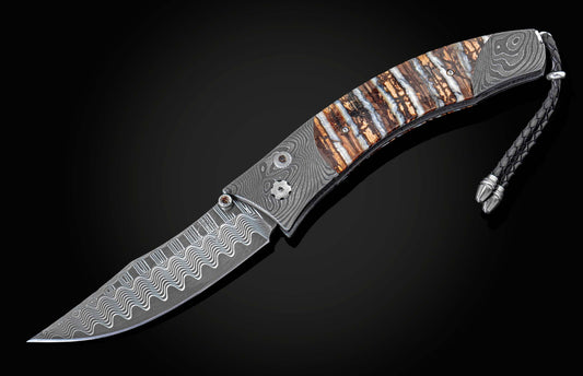 Elegant folding knife with wavy Damascus steel blade, multi-toned handle scales, and a braided black leather lanyard.