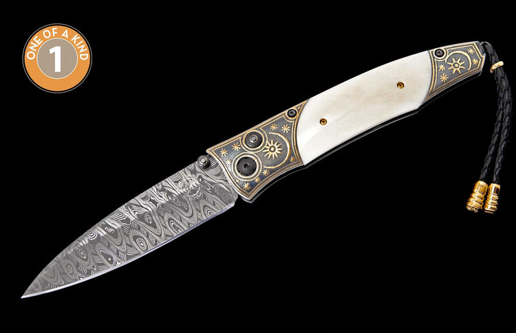 Ornate folding knife with cream handle, Damascus blade, gold-engraved bolsters, and a 'ONE OF A KIND' badge.