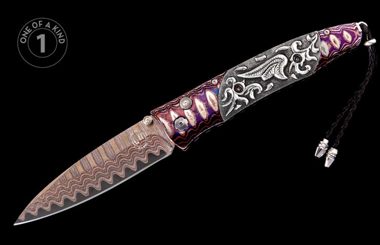 Custom knife featuring a wavy Damascus steel blade, a purple and white patterned handle with silver accents, an ornately carved silver handle, and a black braided lanyard, side view.