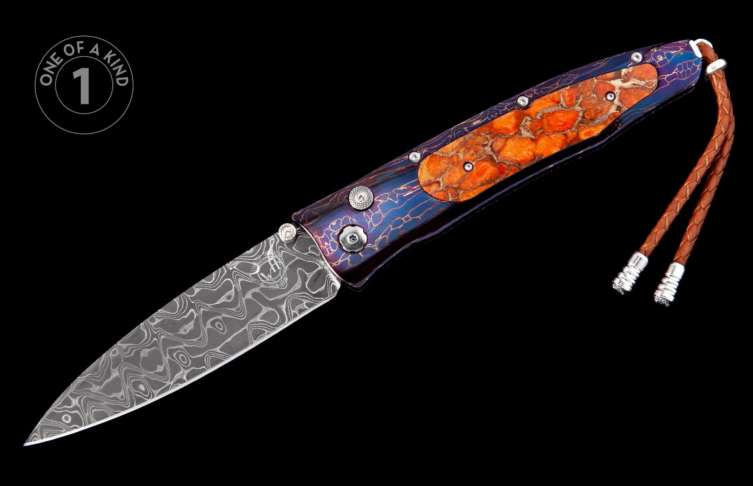 Folding knife with swirling Damascus blade, blue patterned handle with orange textured inlays, and a brown leather lanyard.