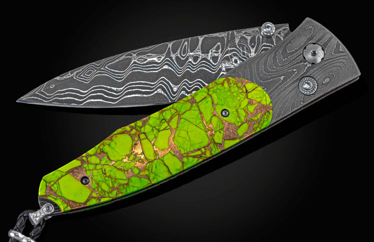 Handcrafted knife from William Henry features hand-forged 'Twist' damascus steel by Chad Nichols, inlaid with a  stunning scale of Mojave Green turquoise & copper, with spinel gemstones.
