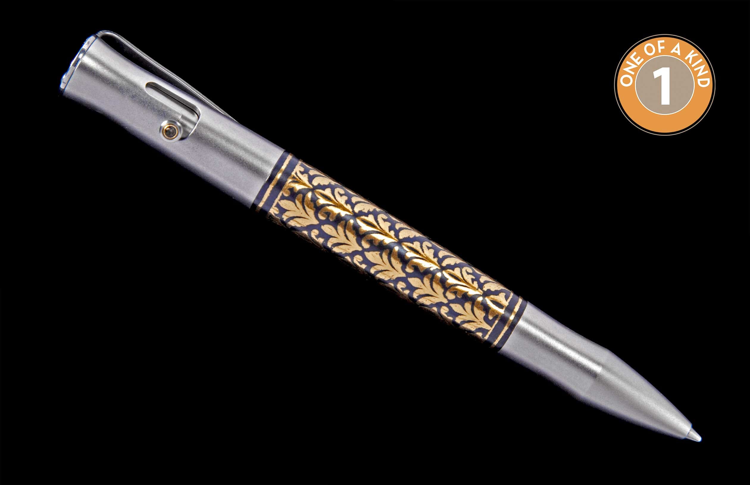Silver metal pen with ornate gold leaf pattern on a dark blue mid-section, bolt-action mechanism, and pocket clip. One of a kind.
