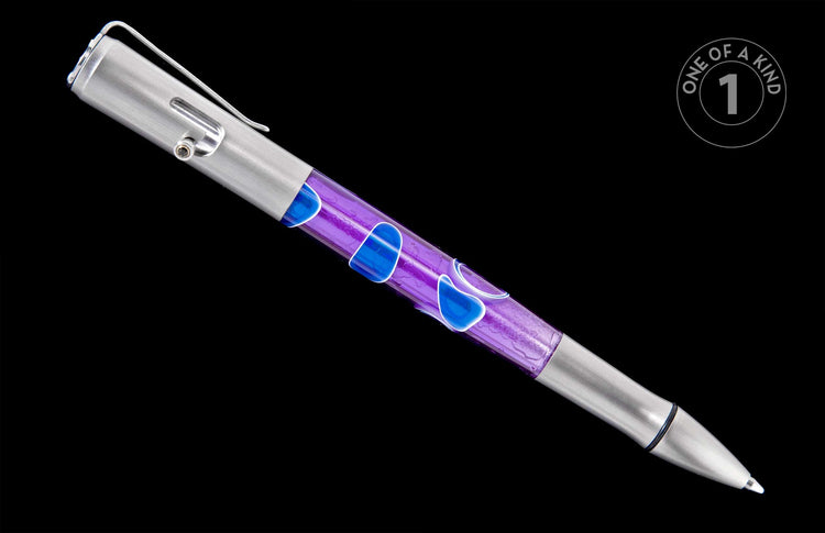 A piece of jewelry designed as a brushed silver pen with a translucent purple barrel and blue liquid shapes.
